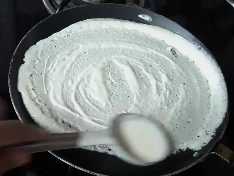 spread batter in circular motion on tawa