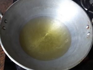 take oil in pan to fry samosa