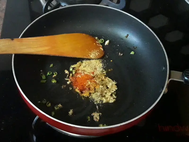 haldi powder, red chili powder and coriander powder in the pan