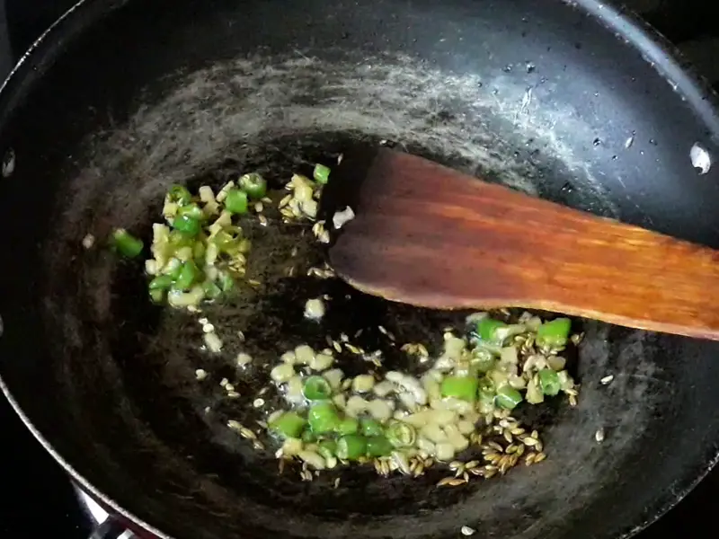 chopped ginger and green chilies frying in oil for samosa stuffing