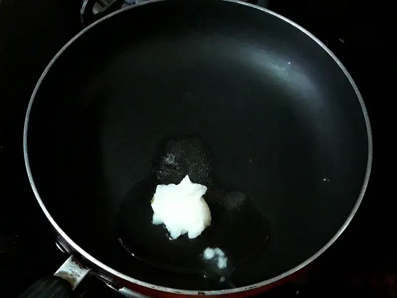 adding desi ghee in the pan for shallow frying of sabudana vada