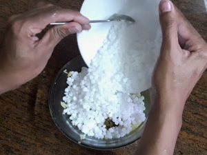 adding soaked sabudana in grated potatoes